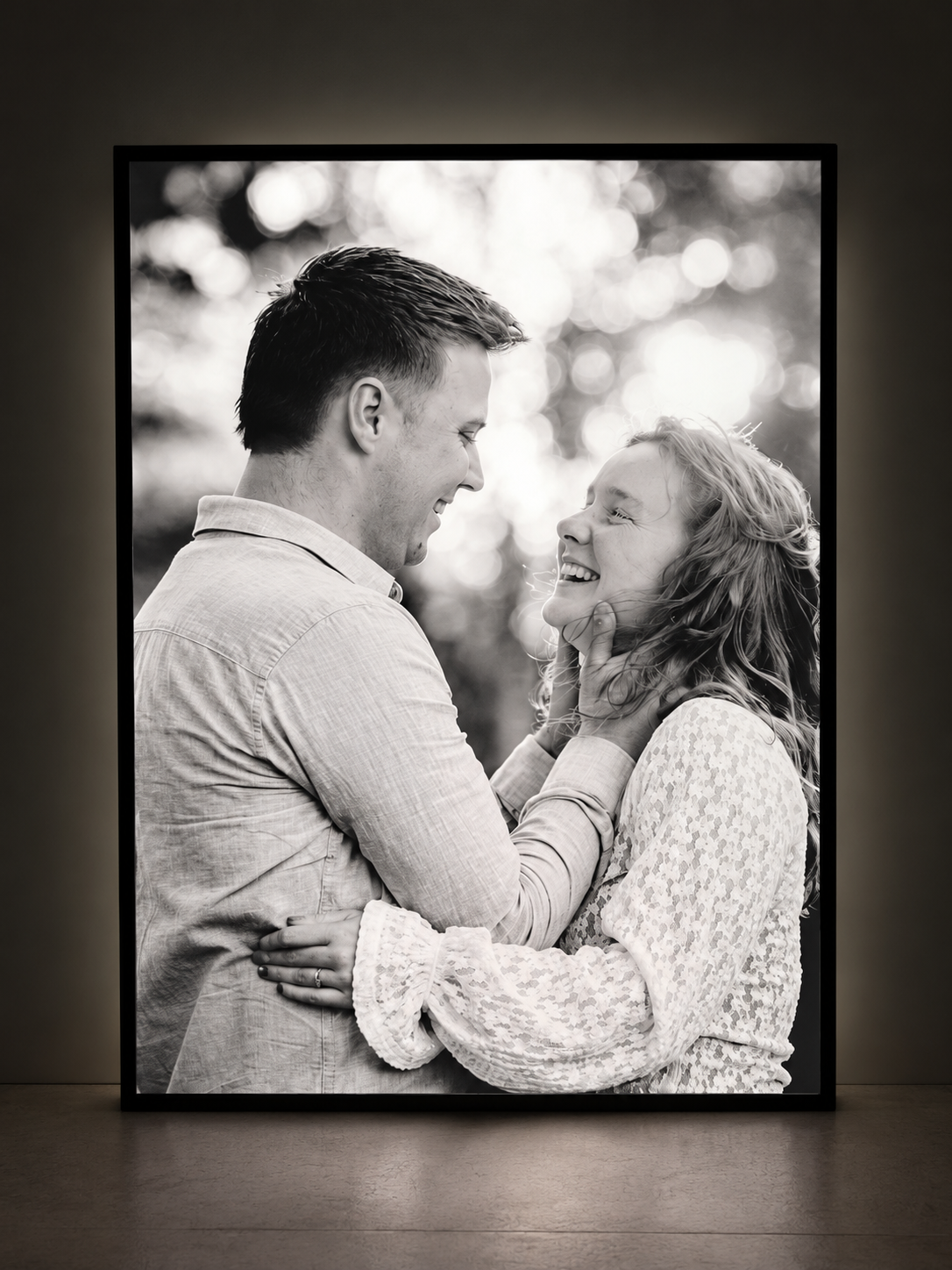 Illuminated photo lightbox featuring a smiling couple in black and white