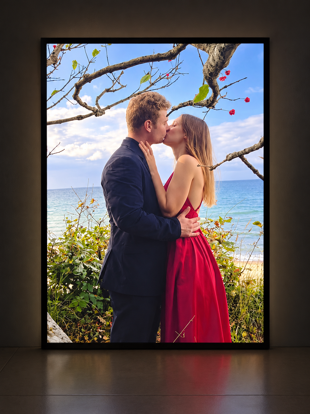 Illuminated photo lightbox featuring a couple kissing beside the sea